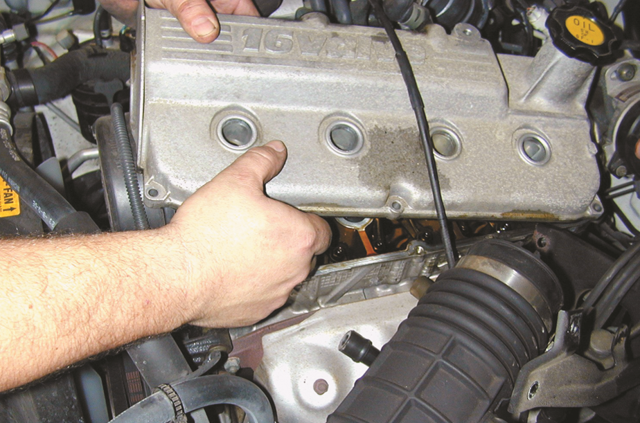 With all vacuum lines and the intake tube removed, the valve cover can be removed after removing all ...