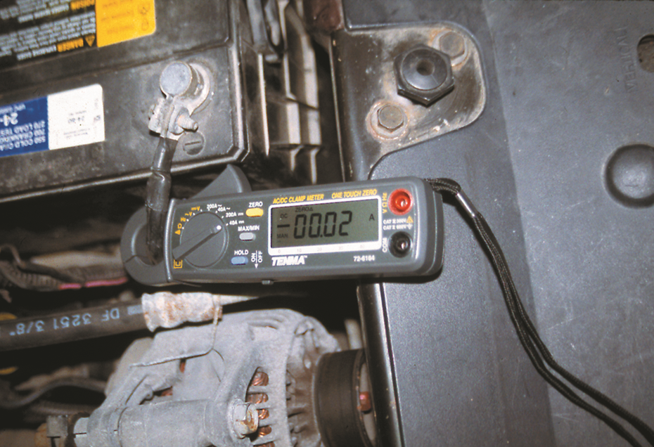 This mini clamp-on DMM is being used to measure the amount of battery electrical drain that is ...