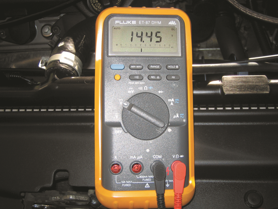 The digital multimeter should be set  to read DC volts and the red lead connected to the battery ...