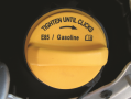 A flex-fuel vehicle often has a yellow  gas cap, which is labeled “E85/gasoline”.