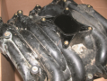 The upper intake manifold, often called  a plenum, attaches to the lower intake manifold.