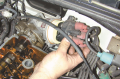 To help locate how far the engine is being rotated,  the technician is removing the distributor cap ...