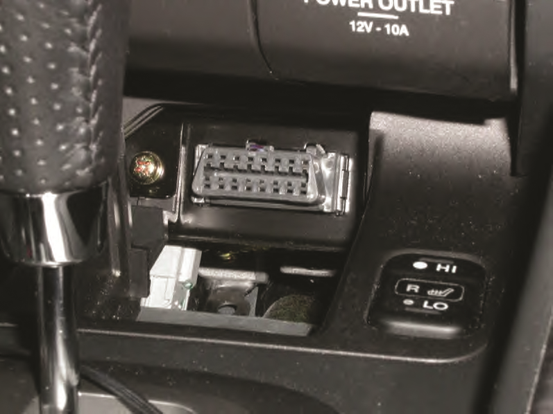 A typical OBD-II data link connector (DLC). The location varies with make and model and  may even be ...