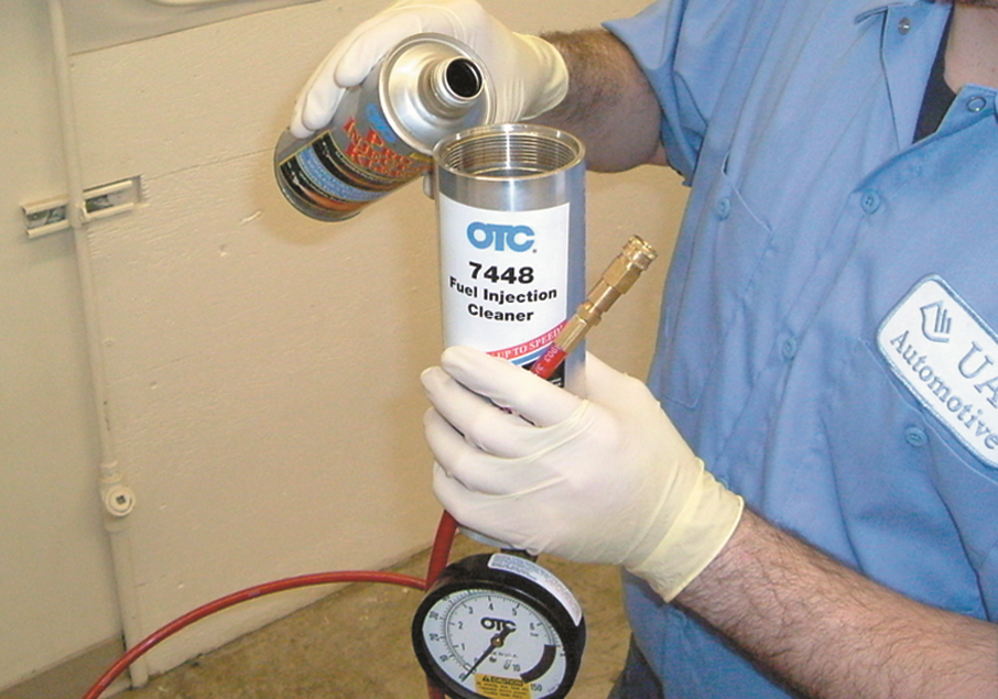 Pour the injection system cleaning fluid into the open canister. Rubber gloves are highly ...