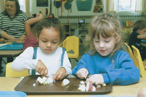 These school-age childrean are eating a health snack