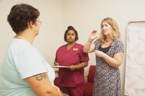 When working with the patient with impaired hearing, the interpreter needs to direct questions to th