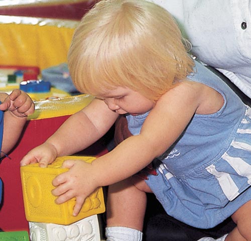 This 11-month old girl demonstrates one of the abilites of a child of this age group - creating a to