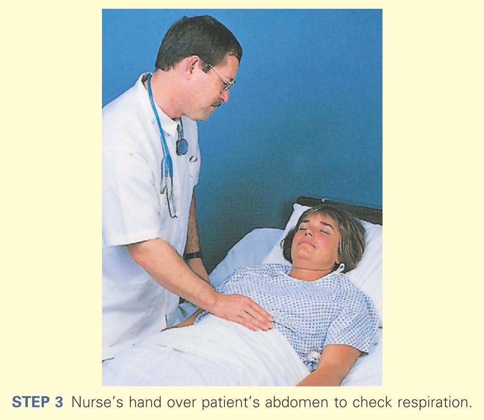 Nurse's hand over patients abdomen