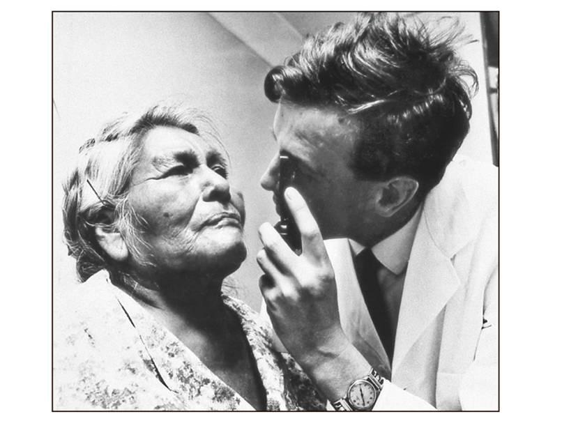 Pima Indian woman receiving an eye exam. 