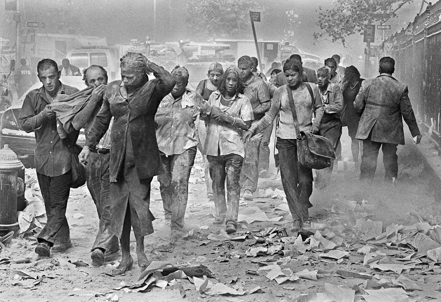 New Yorkers flee from the dust caused by the collapse of the twin towers of the World Trade Center f