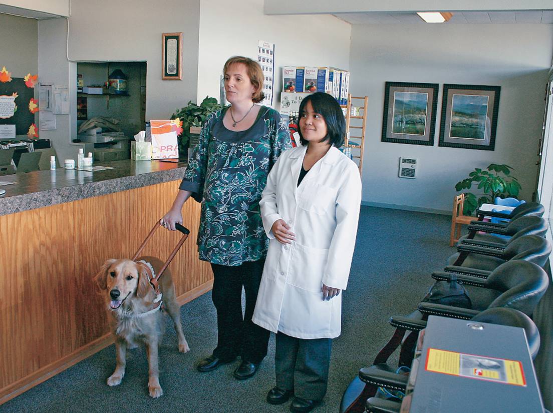 A visually impaired patient is assisted by a service dog. 