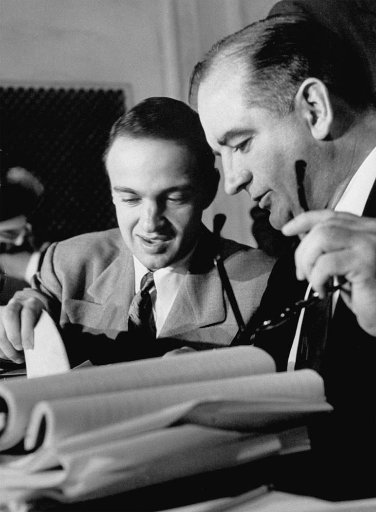 Senator Joe McCarthy and his aide Roy Cohn (left) listen to testimony at the Army-McCarthy hearings ...