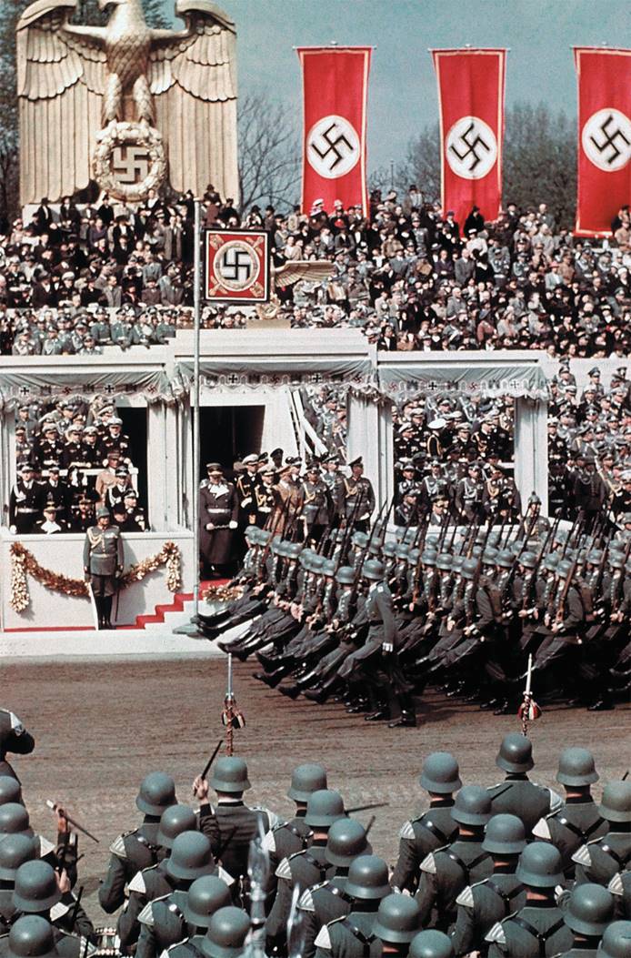 Hitler reviews goose-stepping troops during a celebration of his fiftieth birthday in 1939.