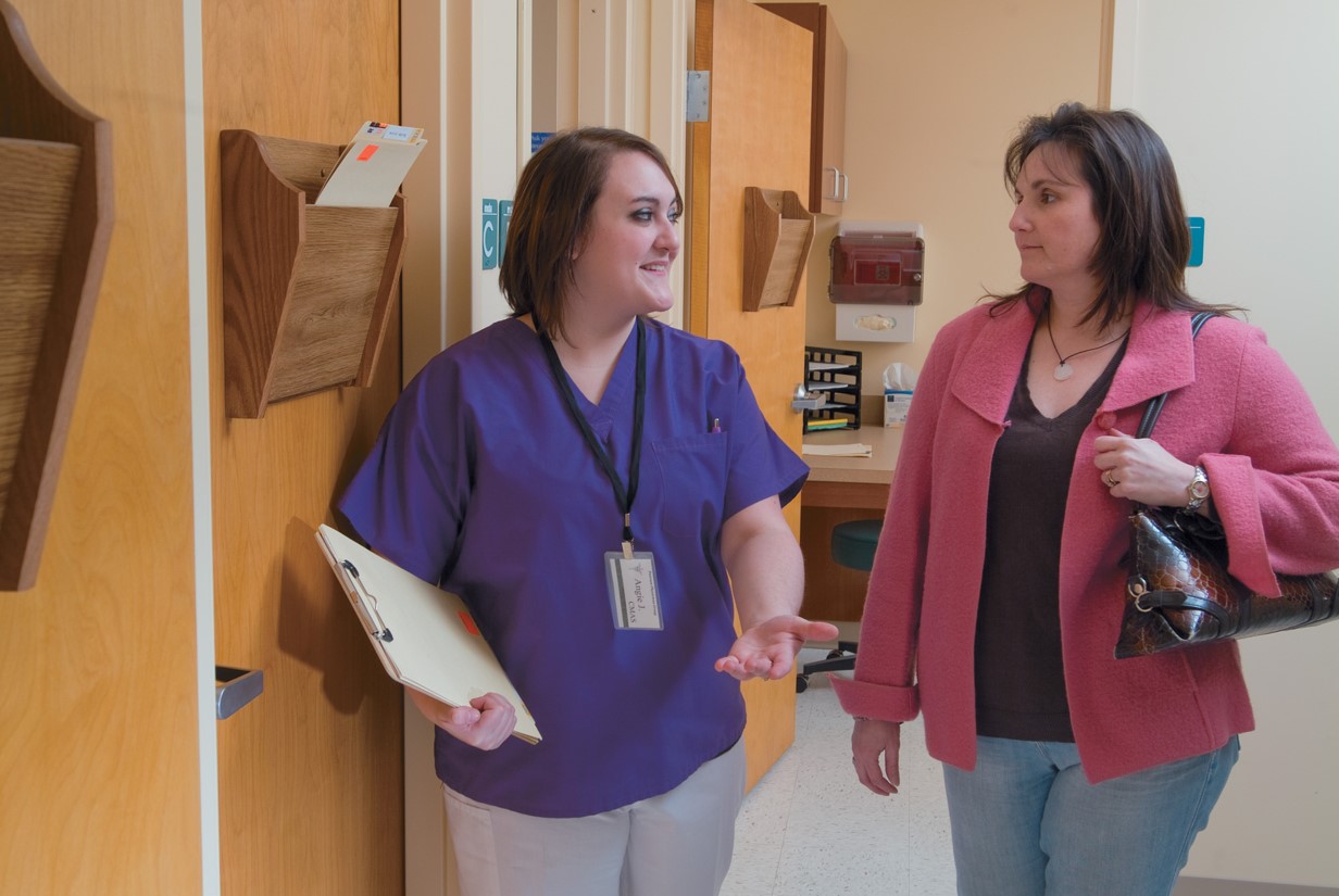 The medical assistant escorts the patient into the examination room.