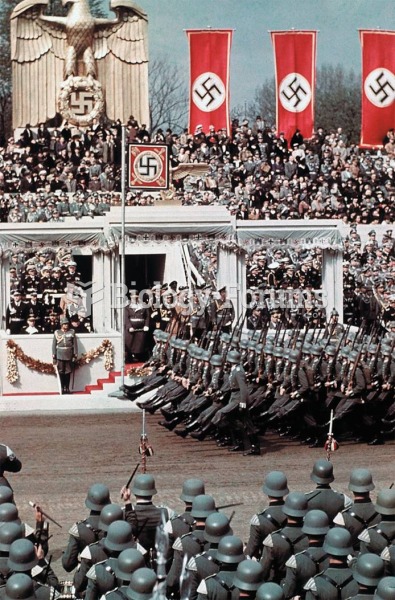 Hitler reviews goose-stepping troops during a celebration of his fiftieth birthday in 1939.