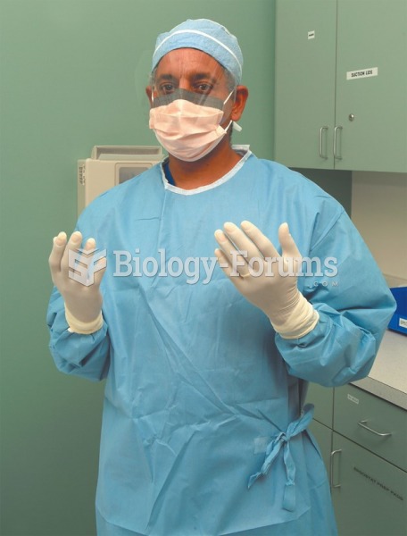 A medical assistant wearing PPE—gown, face shield, and gloves.
