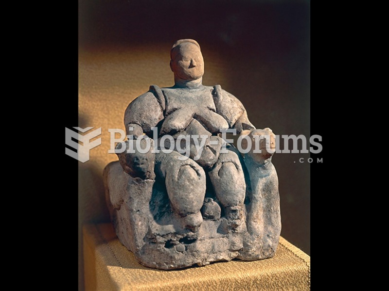 Woman seated between two felines, Çatalhöyük, Turkey. 