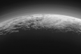Backlit view of Pluto's mountains, plains and foggy hazes