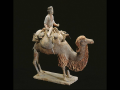 Caravaneer on a camel, China. Tang dynasty, (618–907). Polychrome terra-cotta figure. 